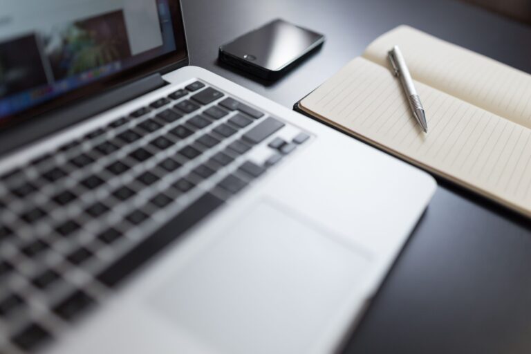 Freelance workspace with a laptop and notebook