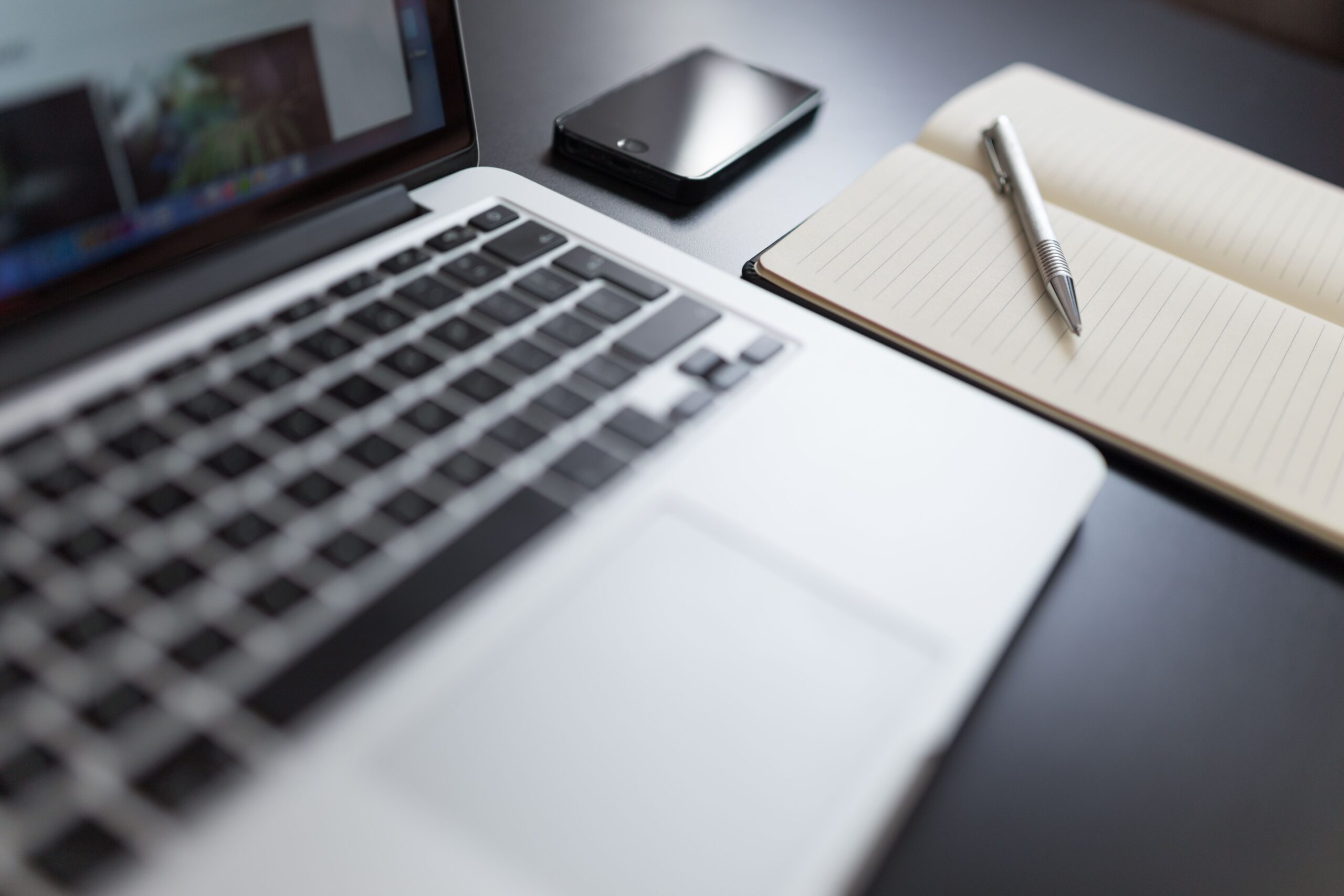 Freelance workspace with a laptop and notebook
