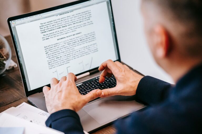 Freelancer typing a client proposal on a laptop
