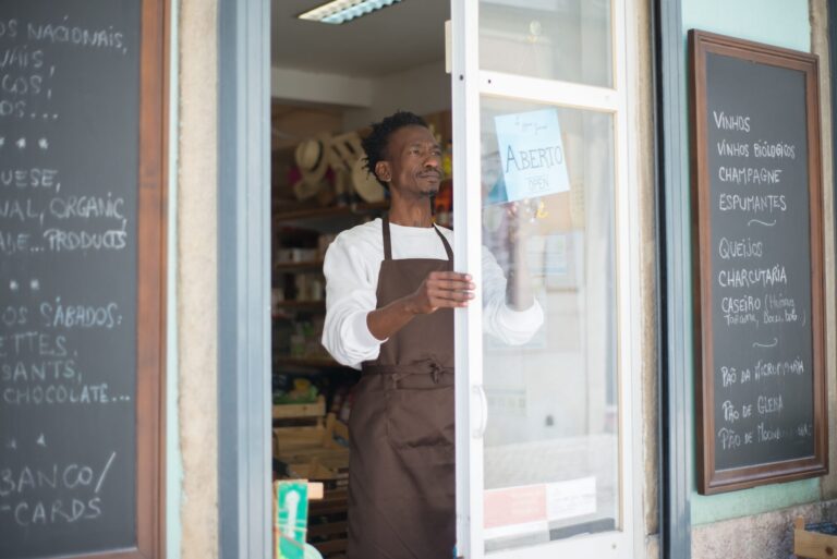 Small business owner standing at their shop entrance