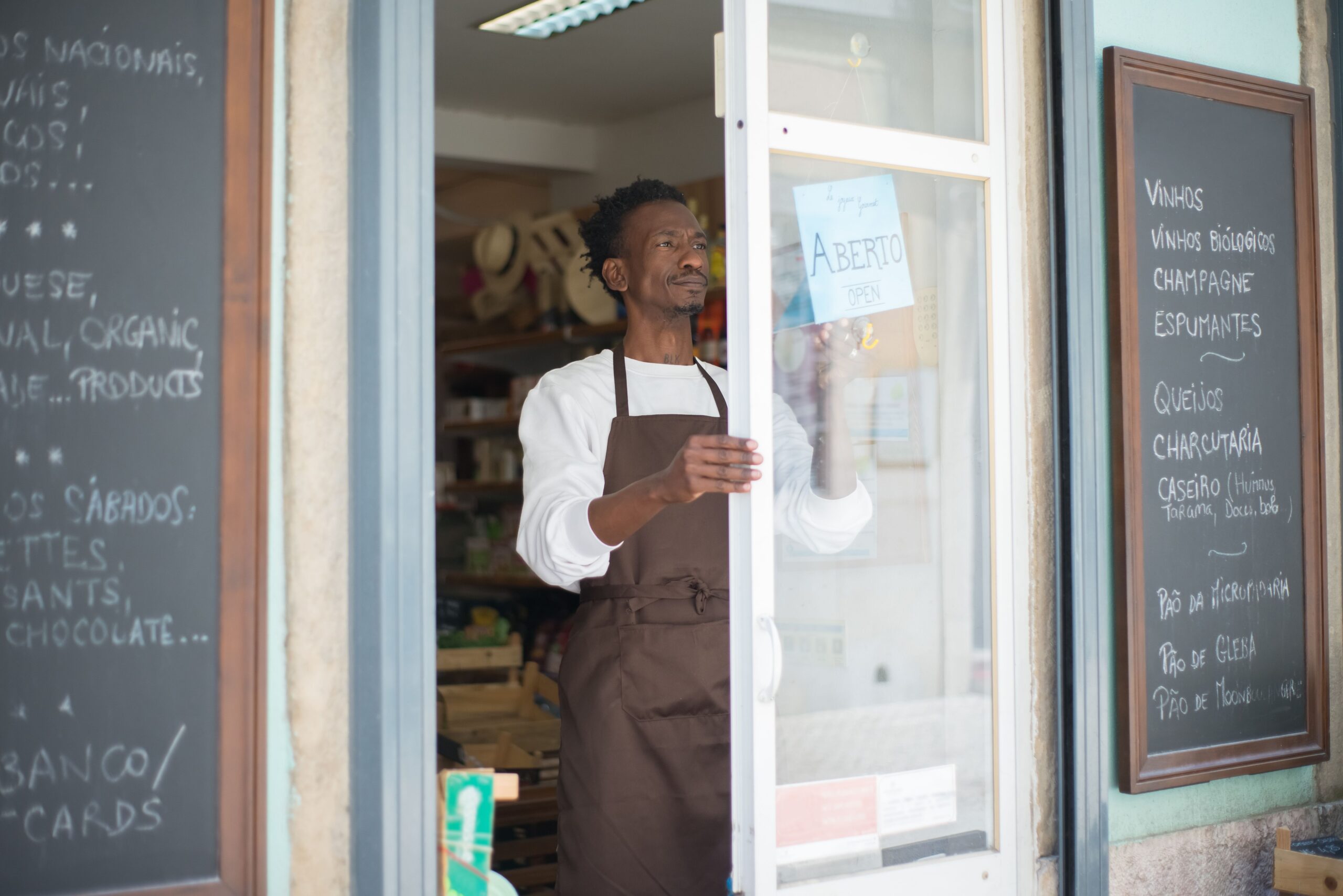 Small business owner standing at their shop entrance